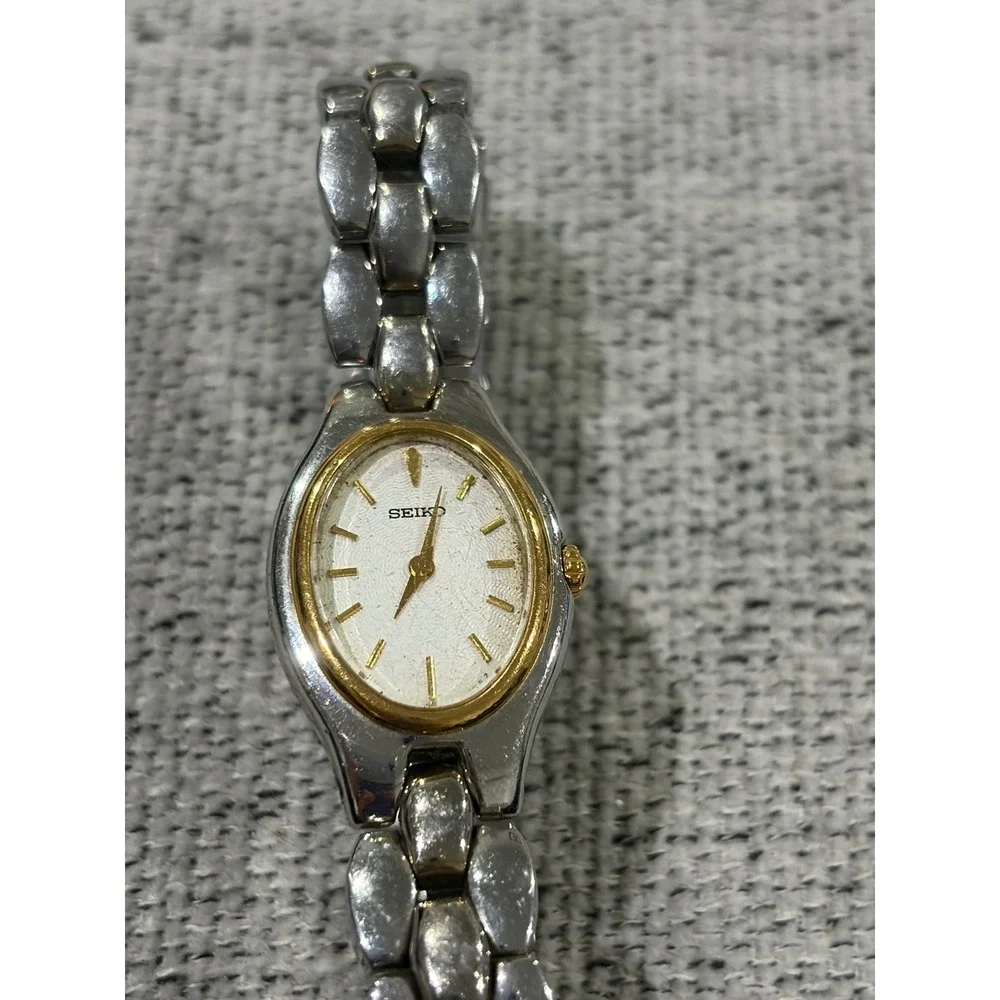 Seiko Oval Women's Two Tone Silver and Gold Wrist  Sunburst Dial Watch 1N00-6F80